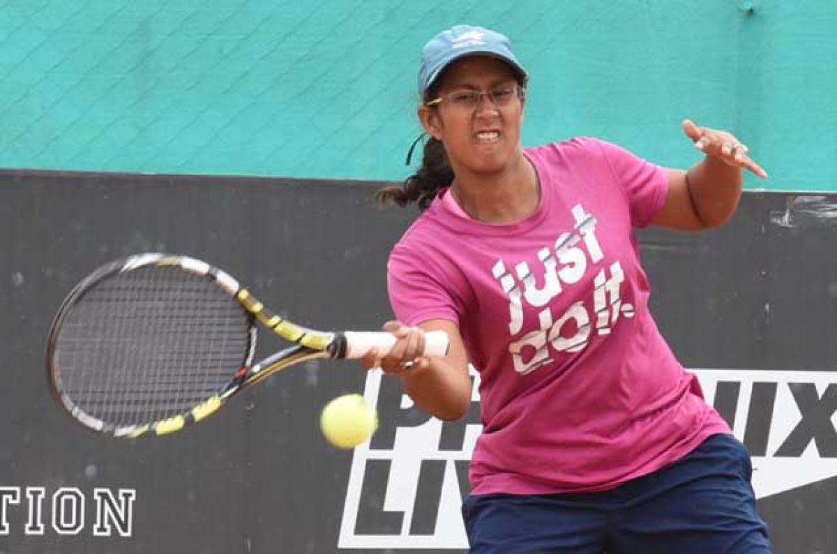 Amritha Mukherjee hits a forhand shot against AksharaIska in the women singles quarterfinals of Phoenix  Live AITA tournament in Hyderabad on Thursday. Photo: Saleem